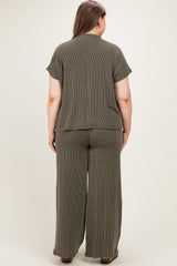 woman wearing an olive green striped maternity plus lounge set, showing the back view of the top and wide-leg pants