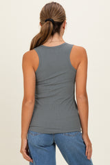 woman wearing a gray ribbed tank top with a fitted style and a scoop back, paired with blue high-waisted jeans