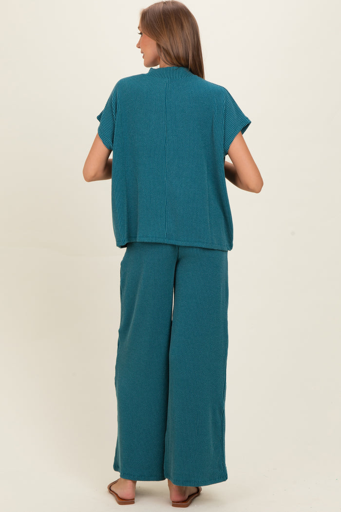 woman wearing a teal striped maternity lounge set with relaxed fit top and wide-leg pants