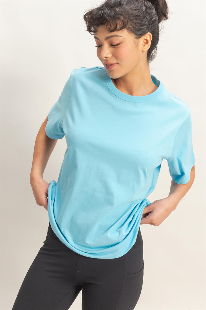 woman wearing a light blue short sleeve t-shirt and black leggings