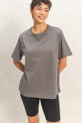 woman wearing a gray short sleeve t-shirt paired with black bike shorts