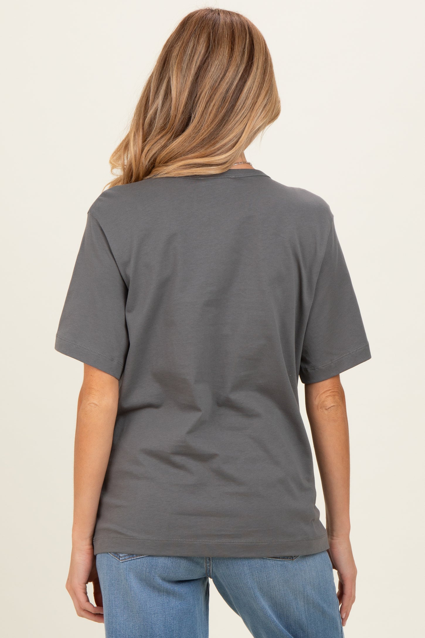 woman wearing a gray maternity t-shirt with short sleeves and a relaxed fit, shown from the back