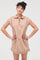 woman wearing a beige short sleeve zip-up dress with a polo collar and relaxed fit