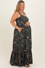woman wearing a black floral maternity maxi dress with a ruffled hem and pockets, showcasing her baby bump