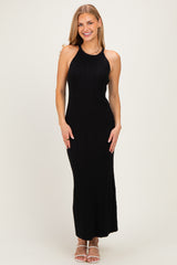 woman wearing a black ribbed maxi dress with a halter neck and a fitted silhouette
