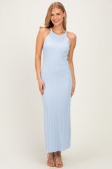 woman wearing a light blue ribbed maxi dress with a halter neck and a fitted silhouette