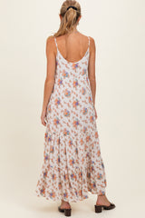 woman wearing a floral maxi maternity dress with adjustable straps, shown from the back