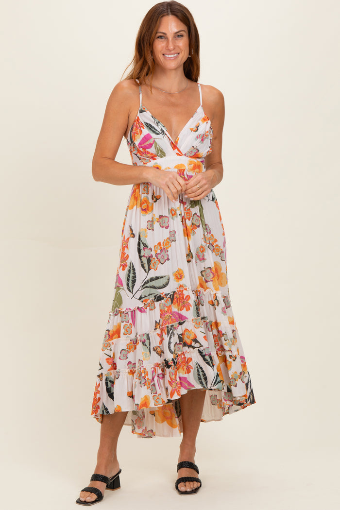 woman wearing a floral print midi dress with a ruffled hem and spaghetti straps