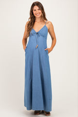 woman wearing a light blue maternity maxi dress with adjustable spaghetti straps and pockets