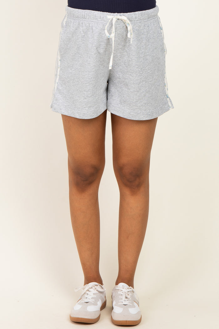 woman wearing gray maternity shorts with a drawstring waistband and side tape details