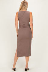 woman wearing a fitted brown midi dress with a side slit, viewed from the back