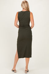 woman wearing a fitted olive green midi dress with a side slit and a sleek design, seen from the back