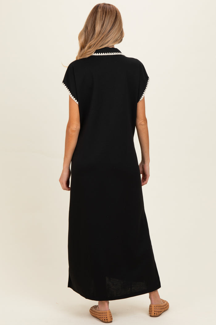 woman wearing a black maternity maxi dress with white trim on the collar, shown from the back