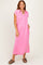 woman wearing a pink short sleeve collared dress with pockets and a relaxed fit