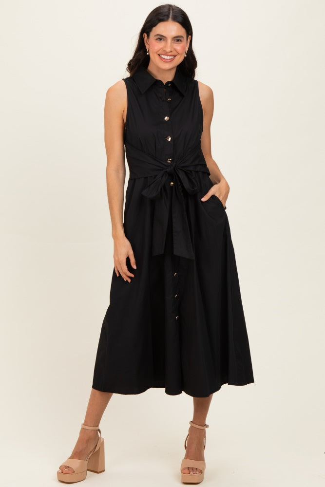 woman wearing a black sleeveless button-up midi dress with a tie waist and side pockets