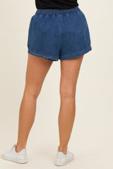 woman wearing dark blue denim shorts with an elastic waistband, seen from the back