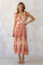 woman wearing a floral print maxi dress with tiered ruffles and tie shoulder straps