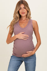 woman wearing a mauve sleeveless maternity tank top and holding her baby bump
