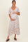 woman wearing a floral maternity dress with short sleeves, holding her baby bump