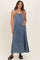 woman wearing a blue denim maternity maxi dress with pockets and a baby bump visible