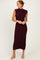 woman wearing a dark burgundy sleeveless ribbed midi dress with a mock neck and side slit