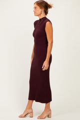 woman wearing a burgundy ribbed midi dress with a mock neck and sleeveless design