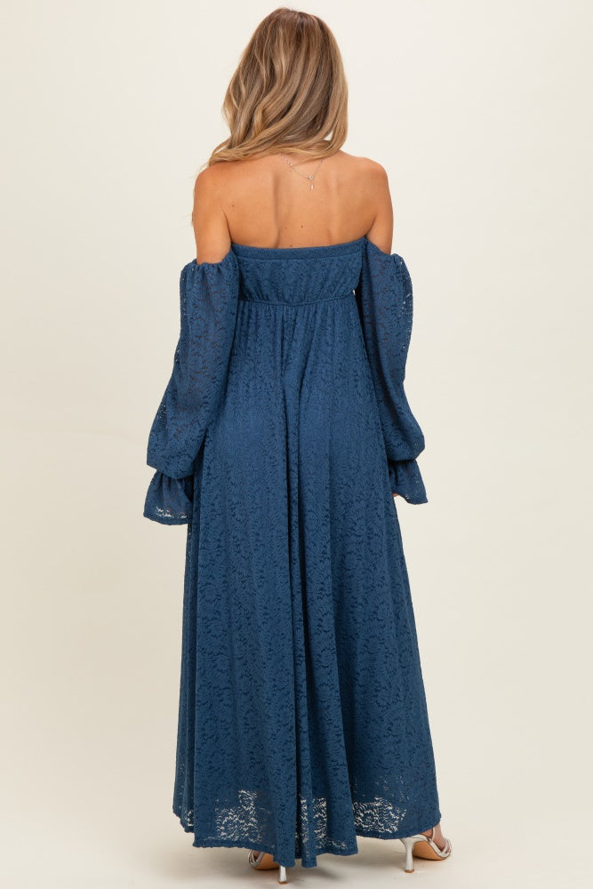 woman wearing a long blue lace off-shoulder maternity dress with balloon sleeves, showing the back view