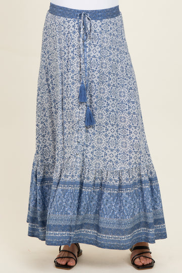 maternity wear maxi skirt in blue with intricate patterns and a tied waistband, model wearing sandals