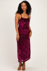 woman wearing a burgundy floral print spaghetti strap maxi dress with curly hair and a confident smile