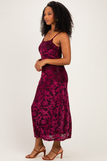 woman wearing a magenta floral print maxi dress with spaghetti straps and a flowy silhouette