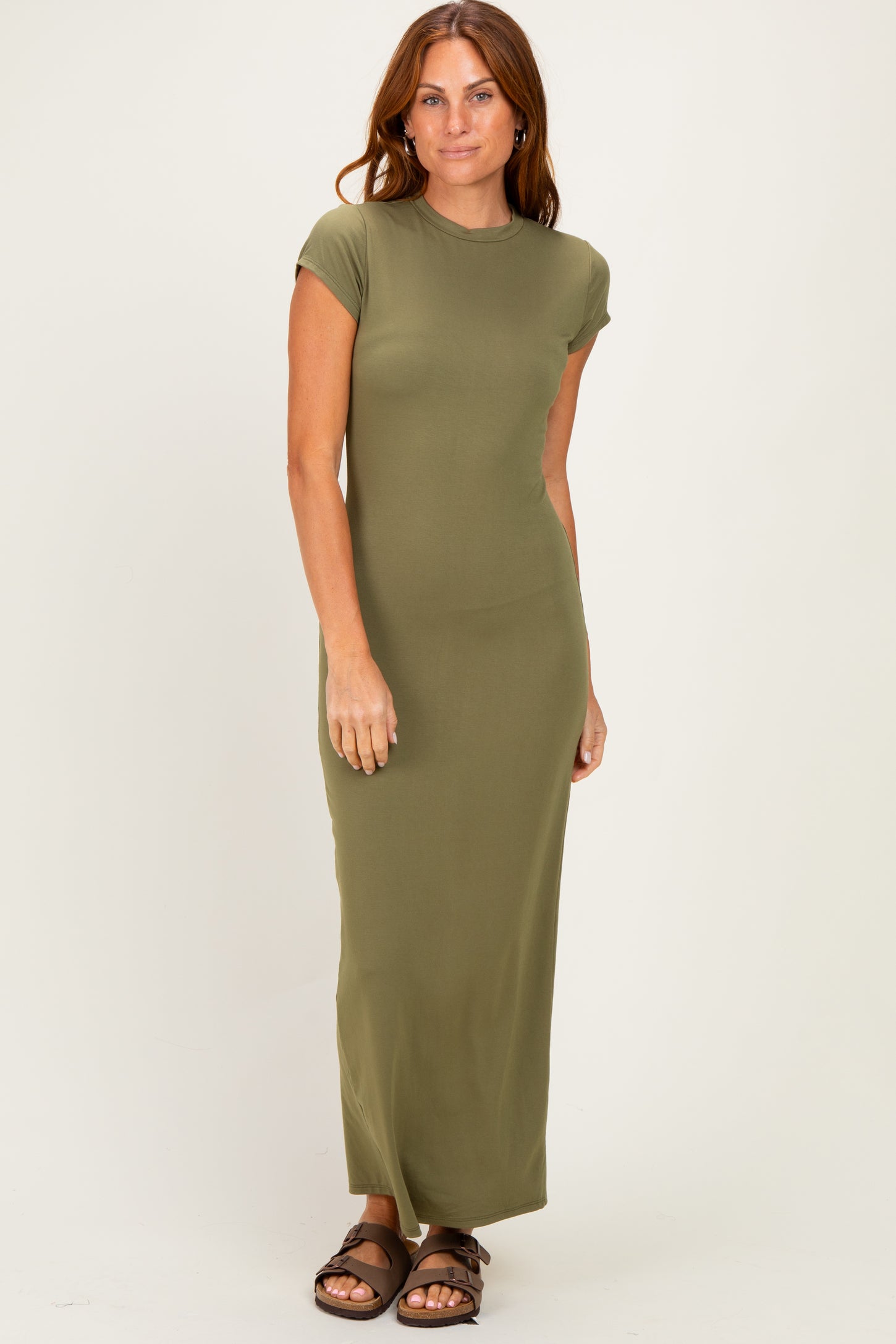 woman wearing an olive green cap sleeve maxi dress and brown sandals