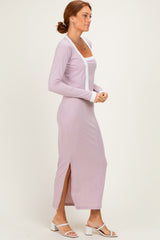 woman wearing a light lavender long sleeve maxi dress with side slits and white trim details