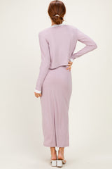 woman wearing a light lavender long sleeve maxi dress with a flowy back and a fitted silhouette