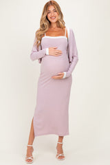 woman wearing a lavender ribbed maternity dress with side slits and a white trim, holding her baby bump