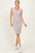 woman wearing a striped sleeveless bodycon dress with buttons and a scoop neckline