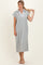 woman wearing a gray midi dress with a collared neckline and short sleeves, styled casually with sandals