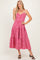 woman wearing a red and white gingham tiered maxi dress with thin straps and a v-neckline