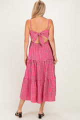 woman wearing a red and white gingham tiered maxi dress with a tied back detail and spaghetti straps