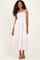 woman wearing a light pink tiered maxi dress with spaghetti straps and a smocked bodice