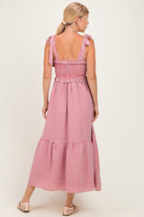 woman wearing a red and white gingham maxi dress with tie shoulder straps and a ruffled hem