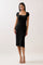 woman wearing a black ribbed midi dress with a square neckline and short sleeves