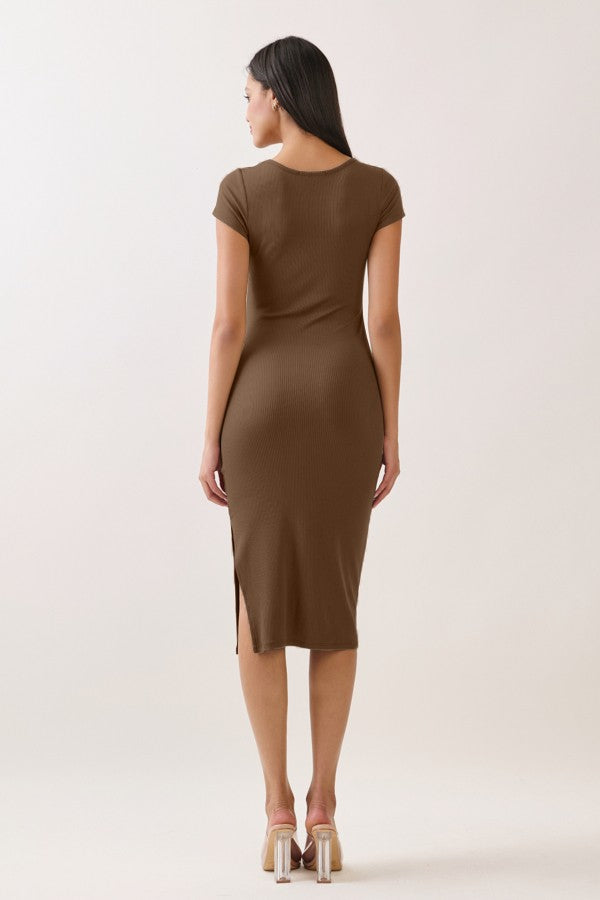 woman wearing a fitted brown midi dress with short sleeves and a side slit