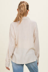 woman wearing a striped beige maternity shirt, view from the back, with loose fit and long sleeves