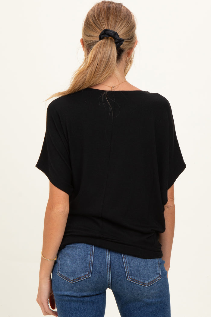 woman wearing a black maternity top, styled with a relaxed fit and short sleeves, seen from the back