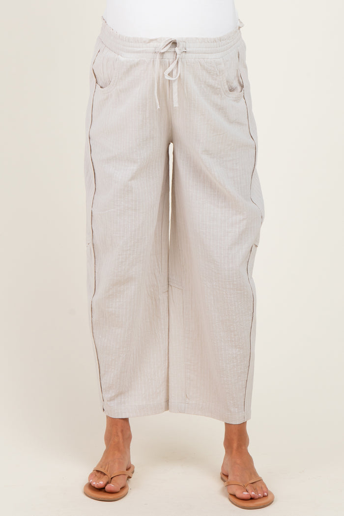 woman wearing light beige breathable maternity pants with a relaxed fit and drawstring waist