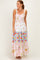 woman wearing a floral maxi dress with a smocked bodice and tiered color blocks in pink, blue, and white