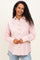 woman wearing a pink and white striped maternity button-up shirt with long sleeves and a relaxed fit