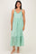 woman wearing a green floral midi dress with ruffled straps and a tiered skirt