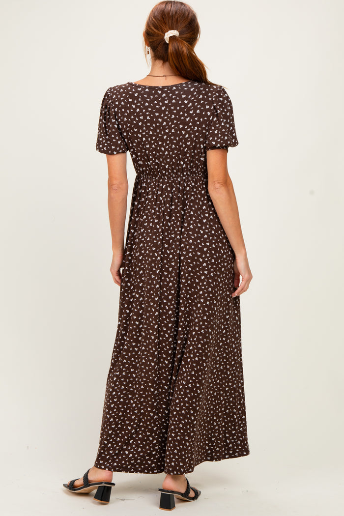 woman wearing a brown maxi dress with white polka dots and short sleeves, showing the back view