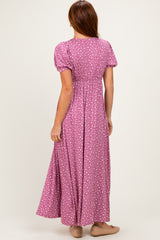 woman wearing a pink maxi dress with white polka dots and puff sleeves, seen from the back